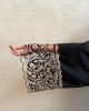 Made by Hadal Embroidered onto the sleeve is an Arabic love poem by Palestinian poet Mahmoud Darwish