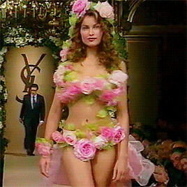 Laetitia Casta wearing the iconic wedding dress made of roses during the Yves Saint Laurent fashion show, 1999 la mariée était en fleur.gif, avr. 2023