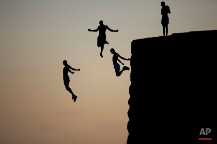 Ariel Schalit Israeli Arab boys jump into the Mediterranean sea from the ancient wall surrounding the old city of Acre northern Israel 2016 sauter dans le vide.jpg