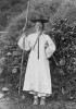 A Korean man in traditional robe and boots (hanbok), wearing a horse hair and bamboo hat (gat), holding a staff and smoking a pipe. 1885.jpg, sept. 2019