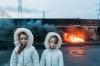 Joseph-Philippe Bevillard Kathleen and Bridget, sisters, Dublin, Ireland 2020 Irish Travellers. In the background, a heap of copper wire is burned to remove the plastic covering portrait des jeunes filles en feu