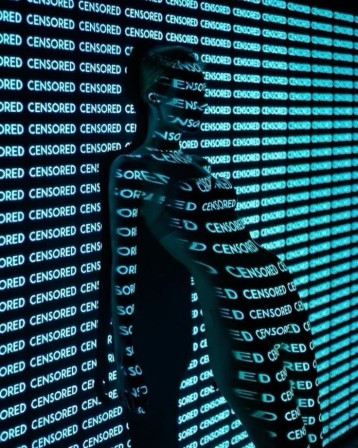 une femme nue le dos au mur sur laquelle sont projetés des centaines de &amp;quot;censored&quot;